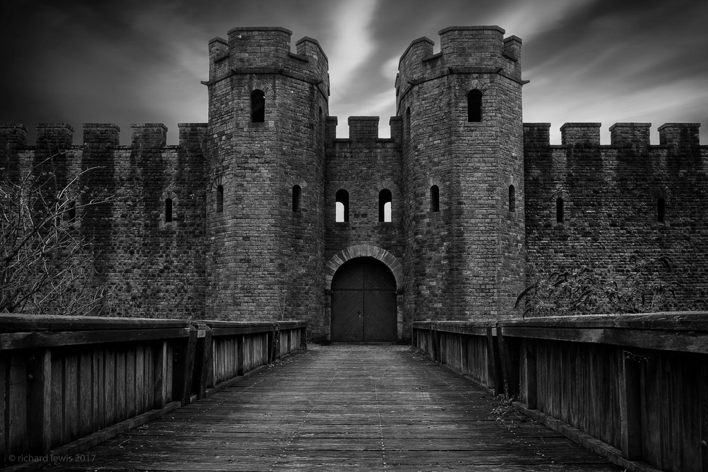 Front of a medieval castle at night